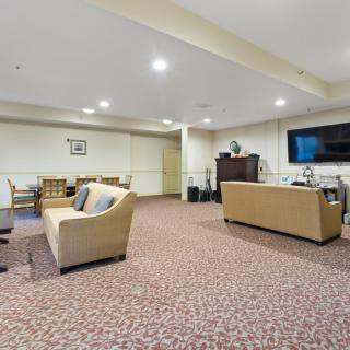 A spacious living room with comfortable seating and a large TV.