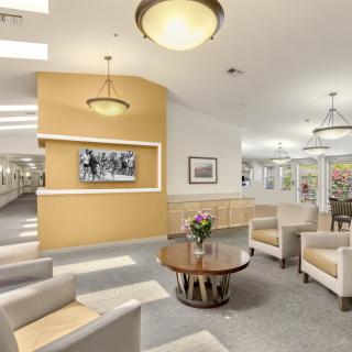 A spacious lobby area featuring comfortable seating and modern lighting.