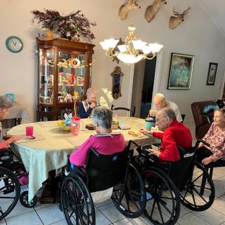 Seniors engaging in a meal together in a cozy dining area.