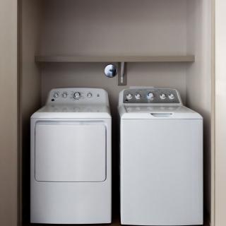 A compact laundry space featuring a washing machine and dryer side by side.