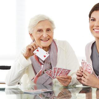 Two women enjoying a game of cards together.