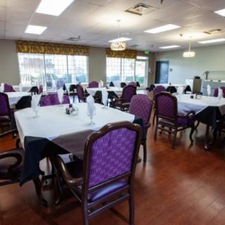 A well-lit dining area with tables set for a meal.