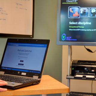 An office setup featuring a laptop and a monitor displaying different screens.