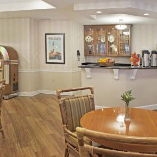 A cozy dining and lounge area featuring a retro jukebox and a beverage station.