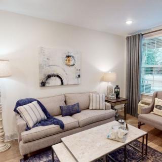 A modern living room with cozy seating, soft lighting, and stylish decor.