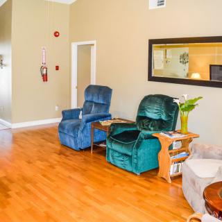 A cozy living room with recliner chairs and wooden flooring.
