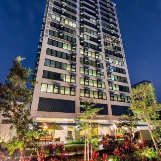 A modern high-rise building illuminated at night.