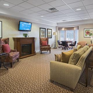 A cozy living room with comfortable seating, a fireplace, and a television.
