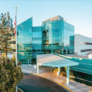 A modern healthcare facility featuring a glass facade and a welcoming entrance.