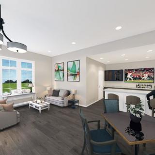 A modern living room with open space, stylish furniture, and wood flooring.
