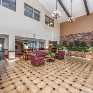 Spacious lobby with seating area and high ceilings.