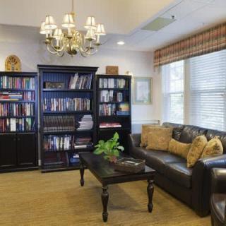 A cozy living room with bookshelves and comfortable seating.