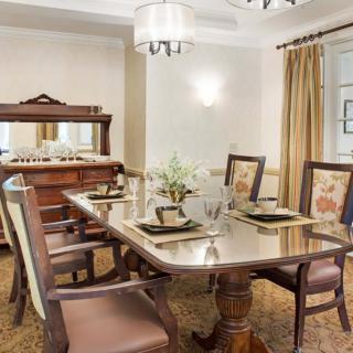 A classic dining room setup with a wooden table, chairs, and elegant decor.