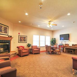 A cozy living room with comfortable seating, a fireplace, and a television.