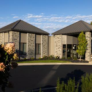 A modern commercial building featuring unique architectural design and well-maintained landscaping.