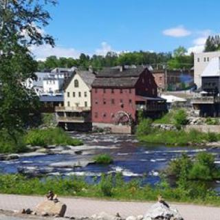 A scenic view of a small town with historic buildings by the river.