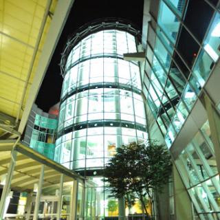 A modern glass structure illuminated at night, showcasing contemporary architectural design.