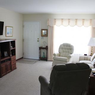 A cozy living room with comfortable seating and a television.
