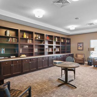 A cozy library with wooden bookshelves and comfortable seating, creating an inviting reading space.