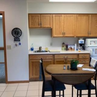 A cozy kitchen with wooden cabinets and a small dining table.