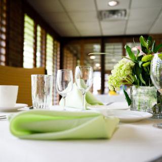 A beautifully arranged table setting featuring a green napkin and fresh flowers, creating an inviting dining atmosphere.