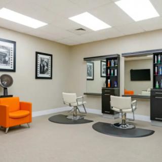 A modern salon interior with stylish chairs and mirrors.