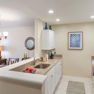 A modern kitchen with a clean and organized design, featuring a countertop, sink, and stylish decor.