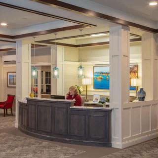 A welcoming reception area with a modern desk and artwork on the walls.
