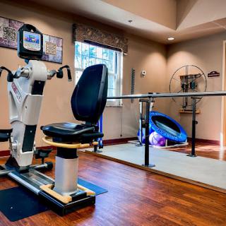 A well-equipped indoor rehabilitation space featuring exercise equipment.