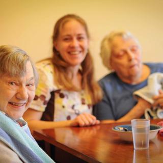 A joyful group enjoying time together at a table.