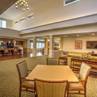 A spacious and modern interior with a dining area and lounge seating.