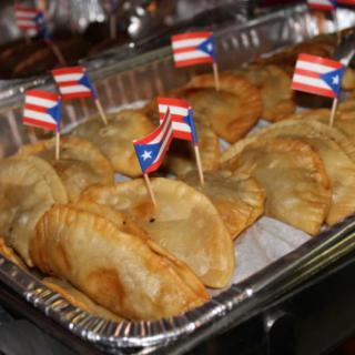 A tray of empanadas adorned with Puerto Rican flags.