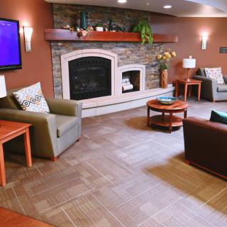A cozy living room with a modern fireplace and comfortable seating arrangements.