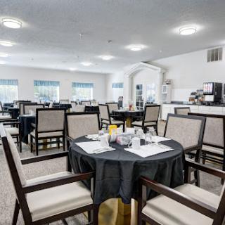 A spacious dining area featuring neatly arranged tables and chairs, perfect for breakfast.
