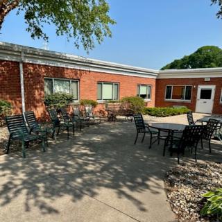 A bright and inviting outdoor courtyard with tables and chairs, perfect for relaxation.