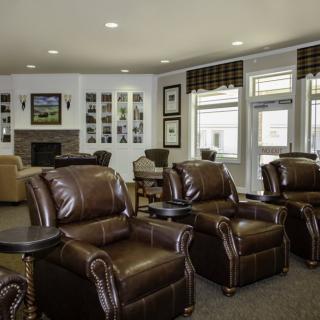 A cozy living room featuring leather recliners and a fireplace.