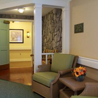 A cozy seating area in a lobby featuring comfortable chairs and warm decor.