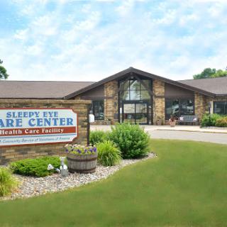 Exterior view of a healthcare facility, showcasing the main entrance and surrounding landscape.