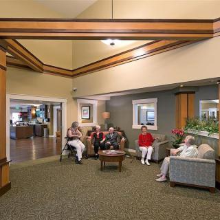 A group of people sitting and relaxing in a comfortable lobby area.