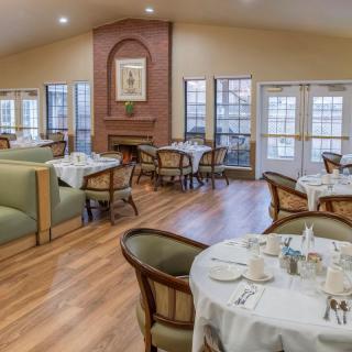 A cozy dining area with neatly set tables and comfortable seating.
