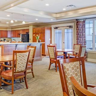 A bright and inviting dining area featuring wooden tables and chairs.