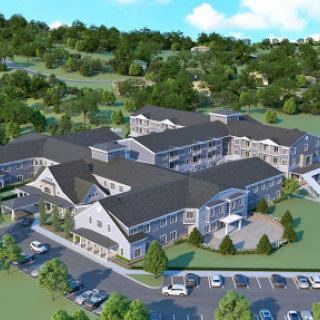 An aerial view of a modern residential complex surrounded by lush greenery.