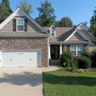 A suburban house with a two-car garage and a neatly maintained front yard.