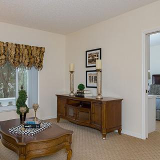A traditional living room with wooden furniture and elegant decor.