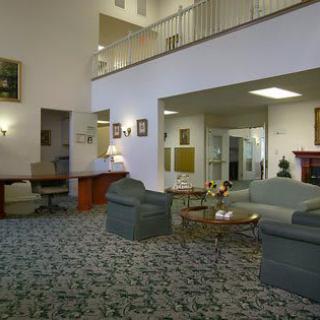 A comfortable lobby area featuring sofas, a coffee table, and soft lighting.
