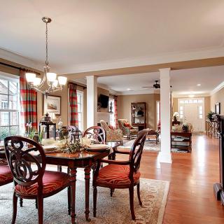 A beautifully decorated dining room with elegant furniture and an open concept design.