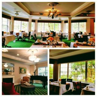 An elegant dining area with large windows, green carpeting, and well-arranged tables and chairs.