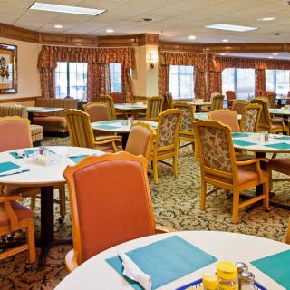 A cozy dining room with neatly arranged tables and chairs.