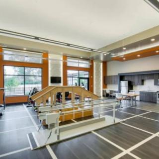 A spacious interior with modern architecture, featuring large windows and contemporary furniture.
