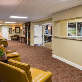 A cozy lobby area with comfortable seating and a reception window.